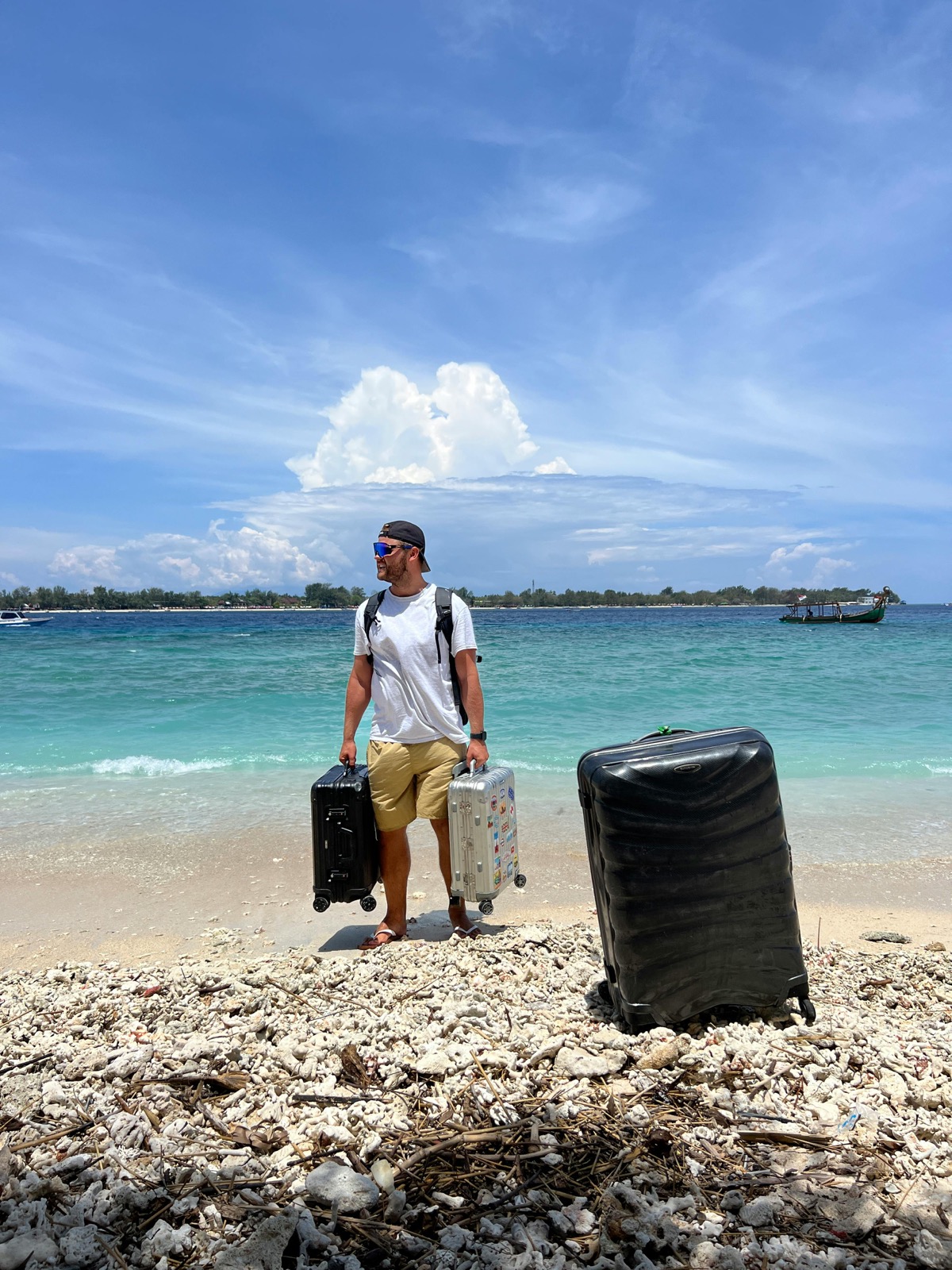 Traveler with heavy luggage near the sea